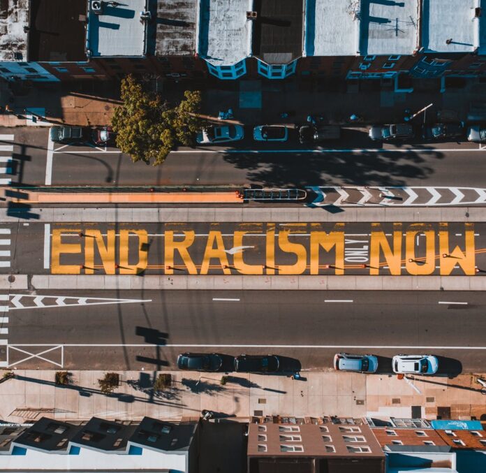 roadway with end racism now title in town